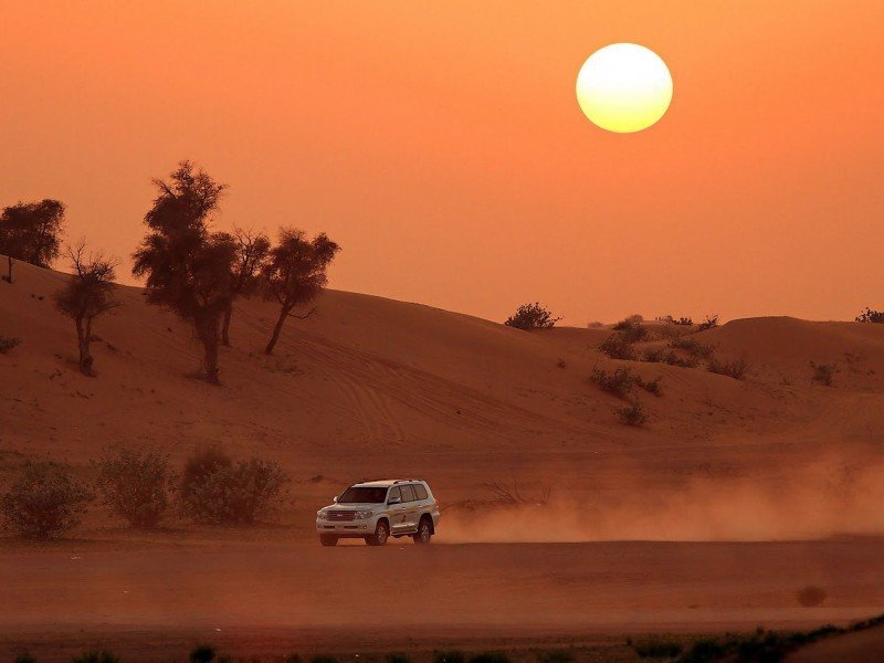 Evening desert safari dune bashing at sunset in Dubai